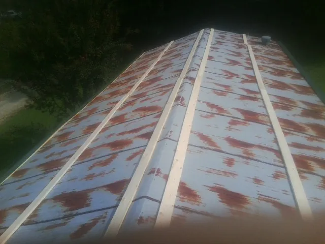 Rusted metal roof panels with new wood purlins before replacement — Storm Damage Roof Repair in Rosebud by Roofing Brothers